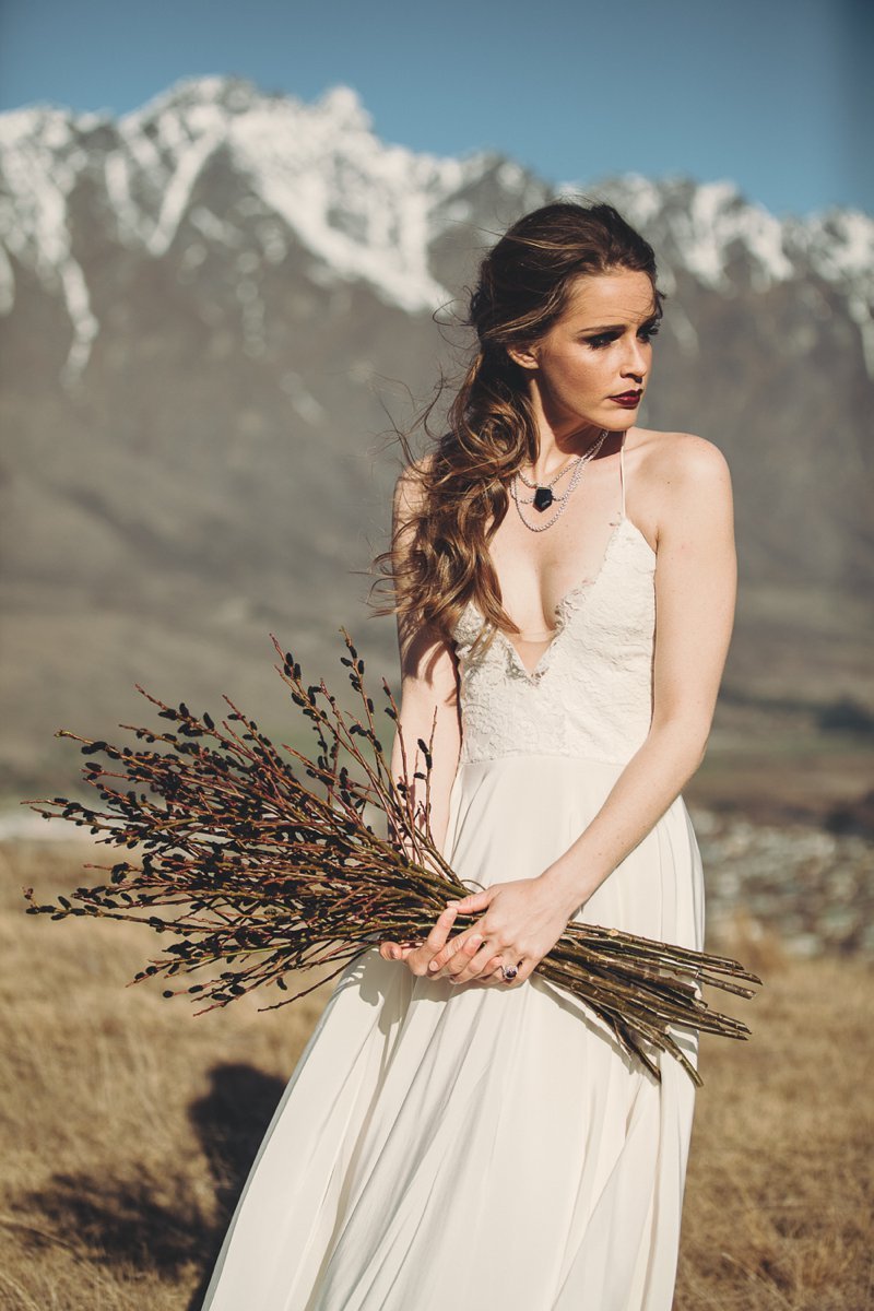 NZ High Country wedding venue with views of The Remarkables and bride wearing Rue De Seine Mackenzie gown and The Flower Room bouquet