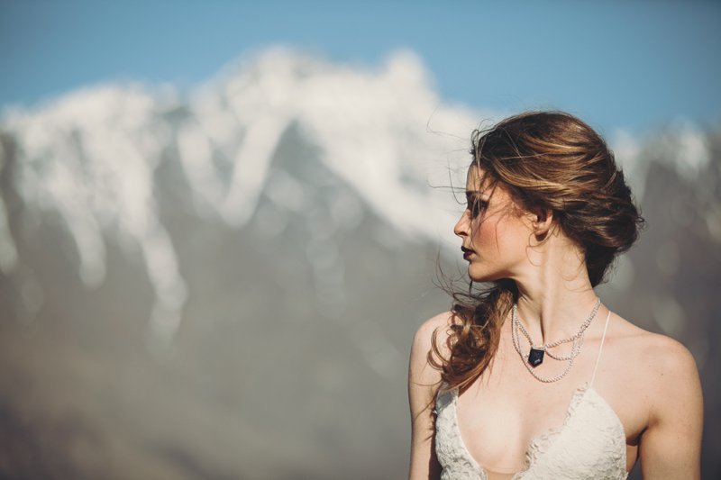 NZ High Country wedding venue with views of The Remarkables and bride wearing Rue De Seine Mackenzie gown and Charlotte Lane accessories
