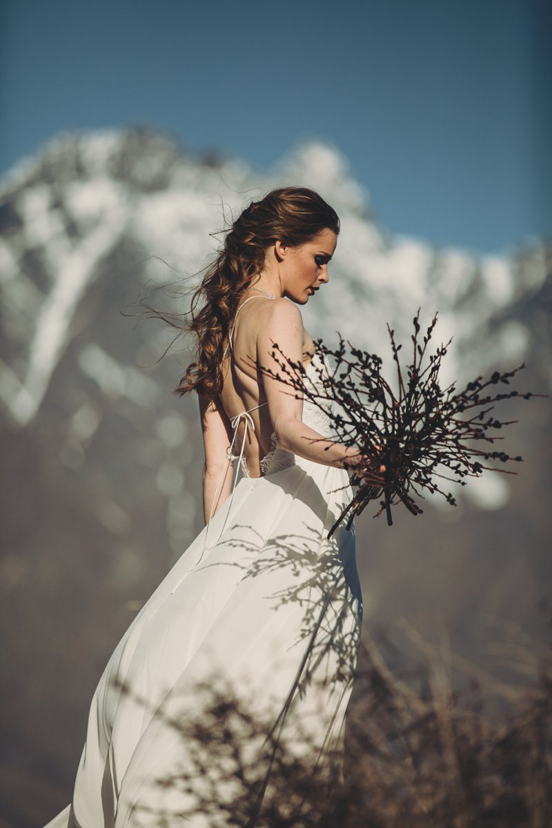 NZ High Country wedding venue with views of The Remarkables and bride wearing Rue De Seine Mackenzie gown and hair by Beautiful Bridal Hair