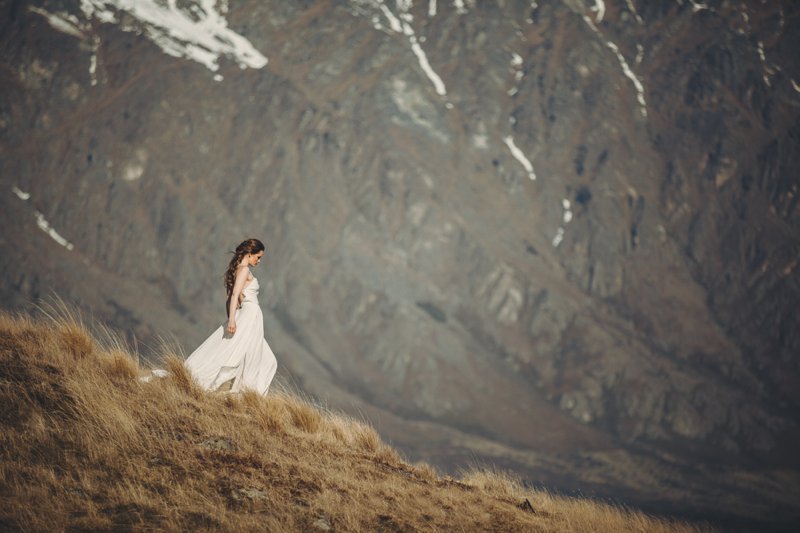 NZ High Country wedding venue with views of The Remarkables and bride wearing Rue De Seine Mackenzie gown and hair by Beautiful Bridal Hair