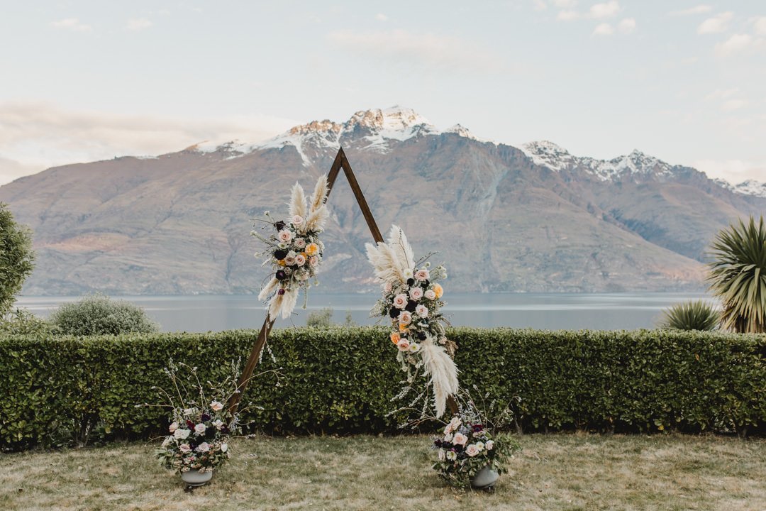 View from Matakauri Lodge Wedding with flower arch by Dawn Thomson Photography