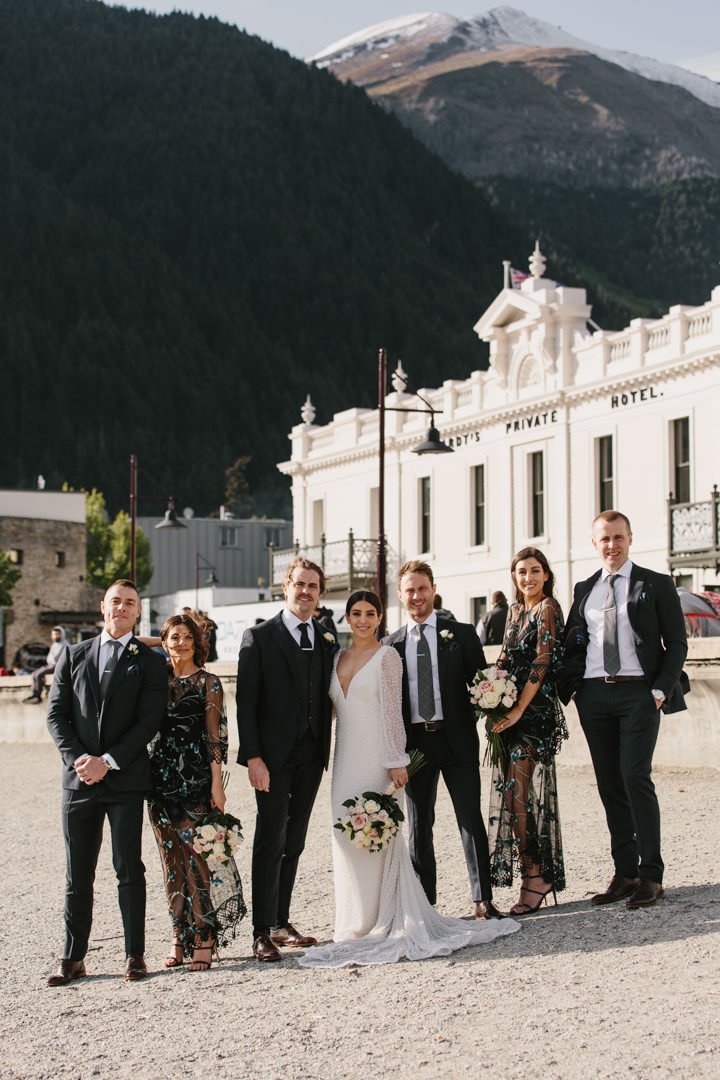 Modern bridal party in front of Eichardts Private Hotel in Queenstown by Dawn Thomson Photography