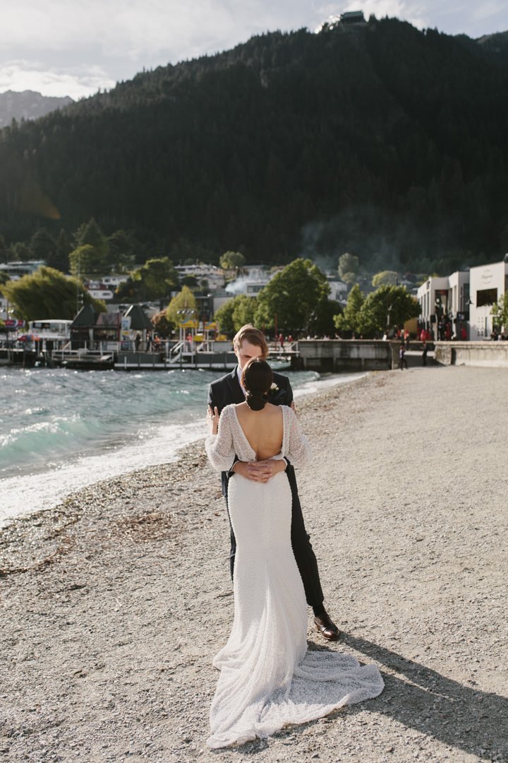 Modern bride and groom in Queenstown New Zealand with lake view in the background at Eichardts Hotel wedding