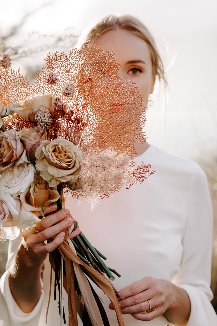 Wedding bouquet with dried coral and Feather and Stone Ribbons at Jacks Retreat Elopement Wedding in Queenstown, New Zealand by Dawn Thomson Photography